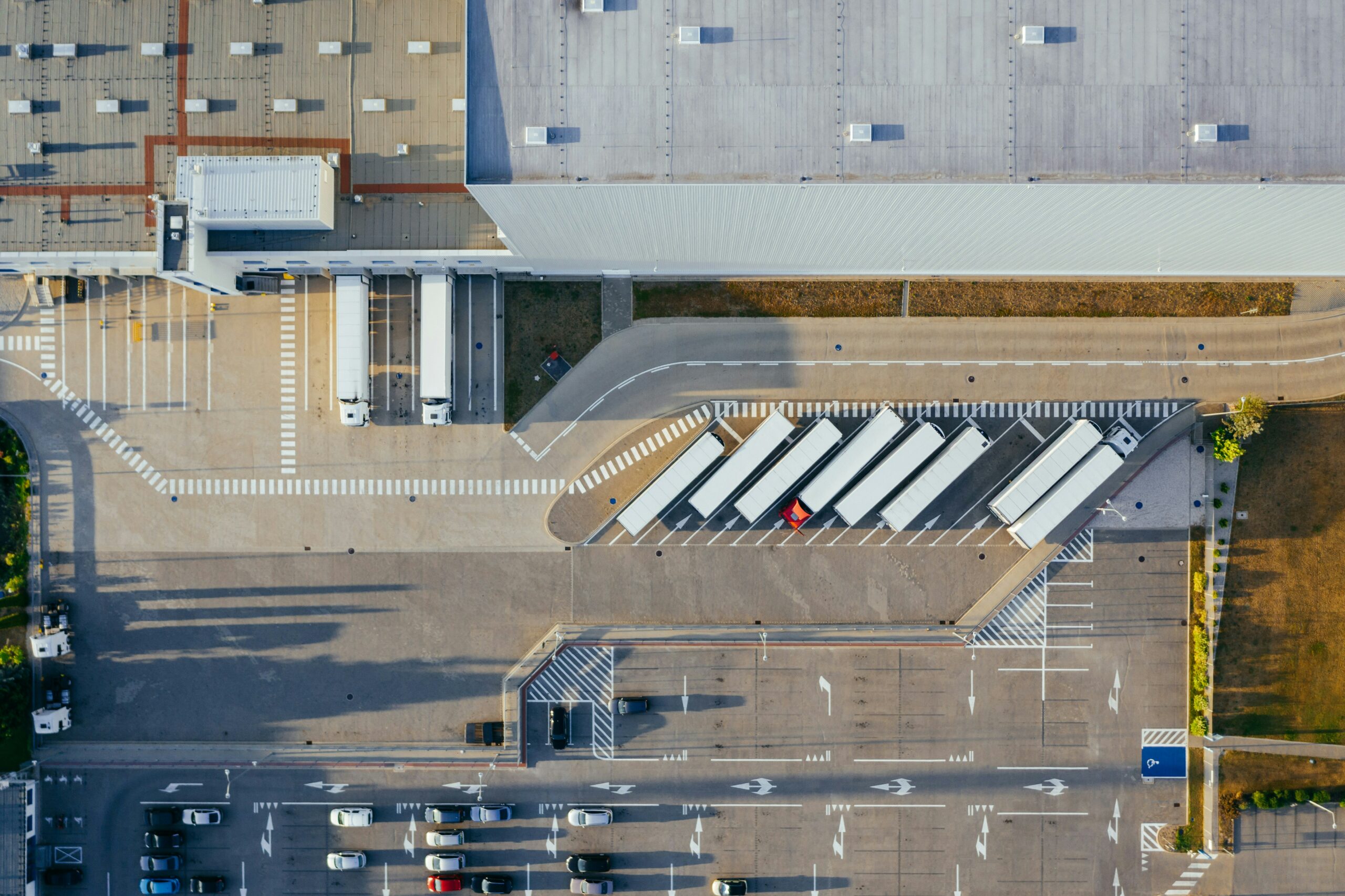 Aerial view of a large distribution center with trailers lined up at loading docks