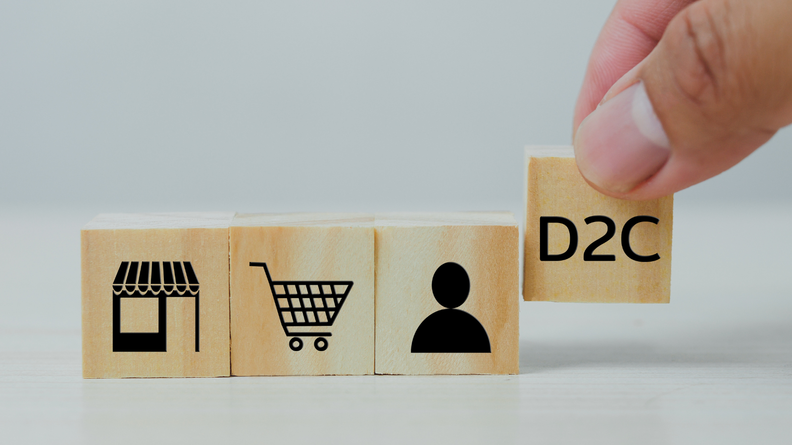D2C ecommerce concept with wooden blocks and retail icons