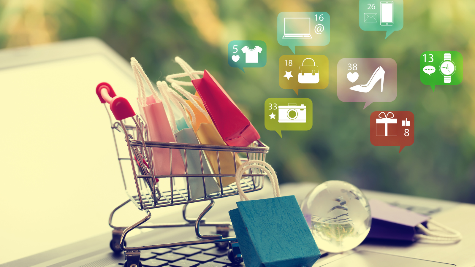 Online shopping concept showing a miniature cart filled with shopping bags and digital notifications representing e-commerce growth.