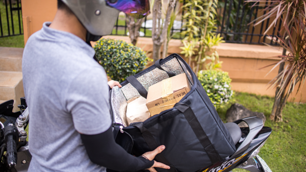 Carrier capacity planning for ecommerce sales showing a delivery worker handling parcels before a peak sale period
