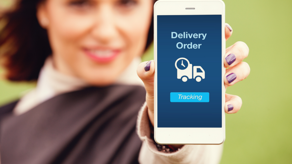 Automated customer shipment notifications showing delivery tracking information sent through a mobile phone