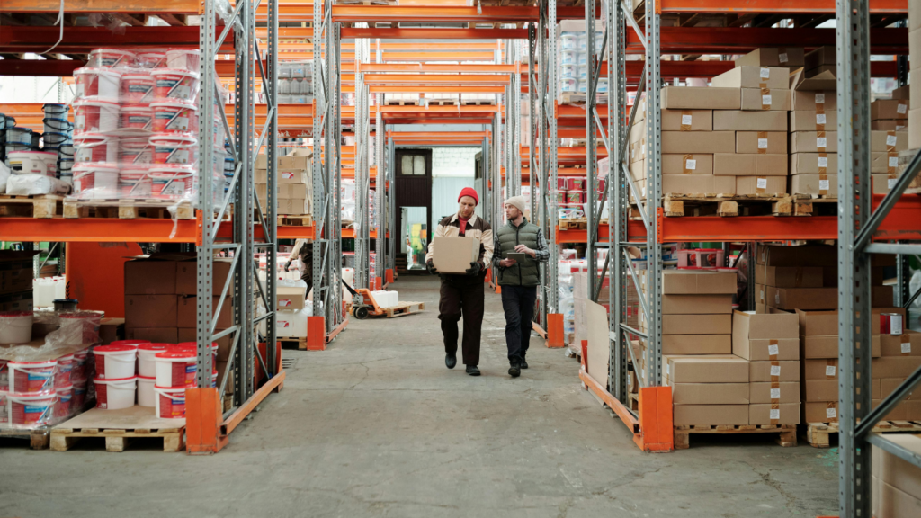 Warehouse staff managing inventory in a modern fulfilment center with organized storage racks
