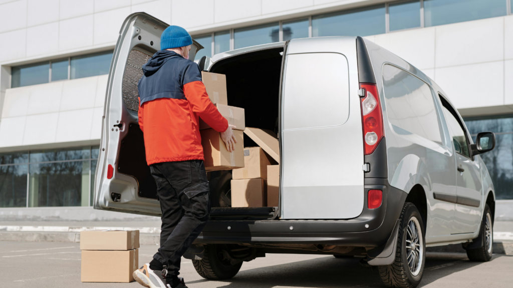 Delivery worker loading ecommerce packages into a vehicle for last-mile fulfilment