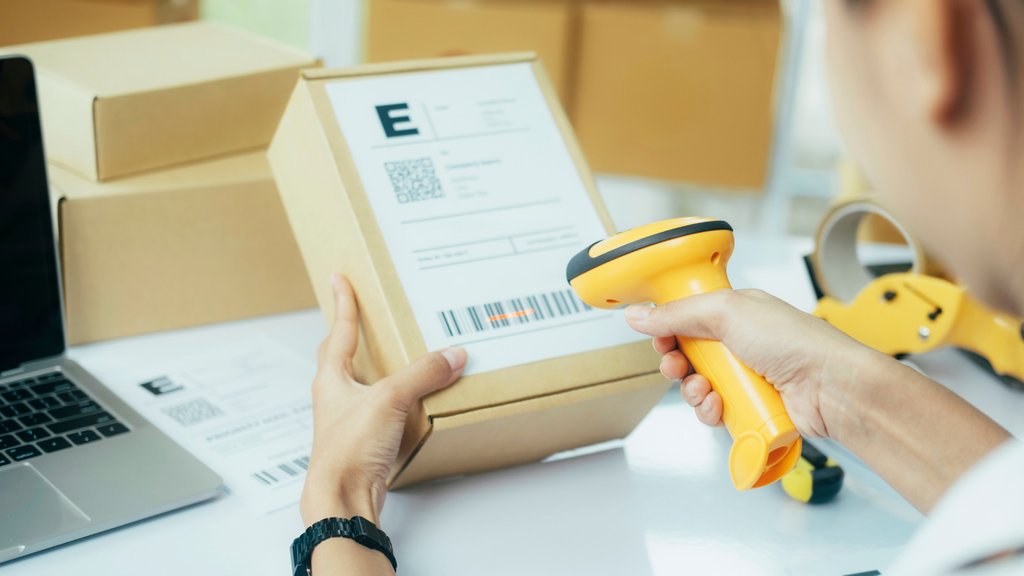 Barcode scanning process showing a warehouse worker verifying package information for accurate inventory tracking