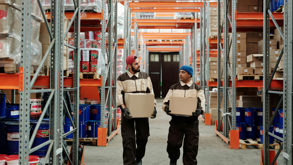 Warehouse workers managing inventory across organized storage locations for multi-warehouse order fulfillment
