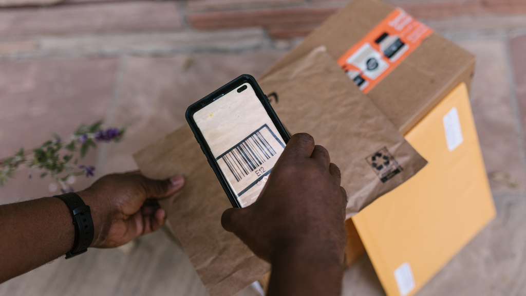 Barcode scanning on ecommerce packages showing verified warehouse picking and shipment processing