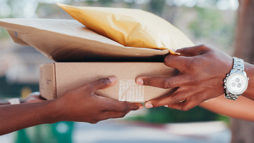 Package delivery scene showing a worker handling and handing over a customer order

