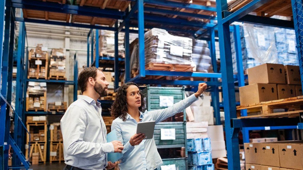 Warehouse operations scene showing teams managing inventory and supply chain activities across a storage facility