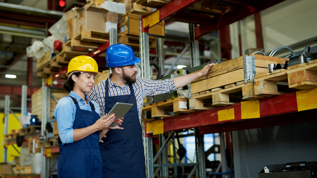 Warehouse workers using digital tools to manage inventory and fulfillment operations in a distribution facility