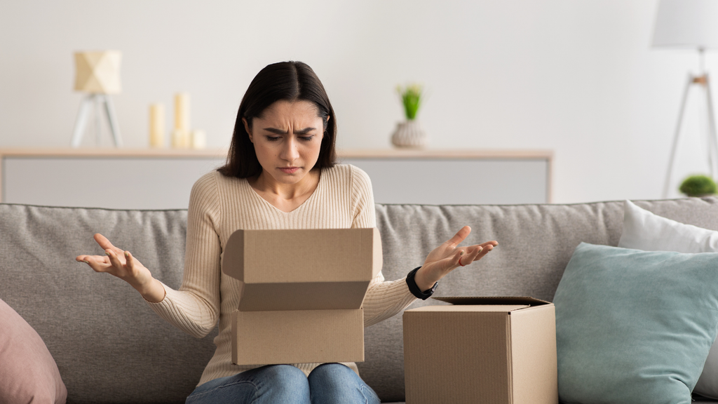 Customer checking a delivered parcel, illustrating the frustration and returns that can result when an online order contains the wrong item.