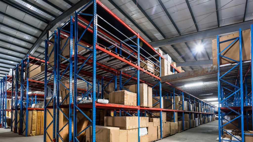 Warehouse storage racks filled with inventory, representing the complexity of assigning couriers across multiple warehouse locations.