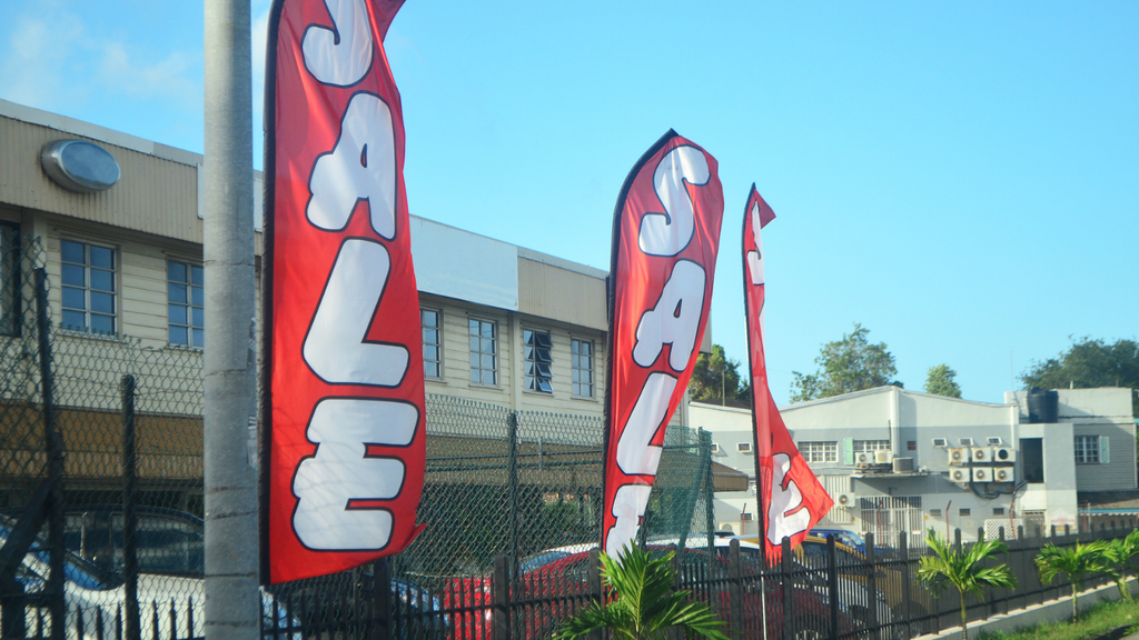 Ecommerce sale event represented by promotional sale banners outside a warehouse