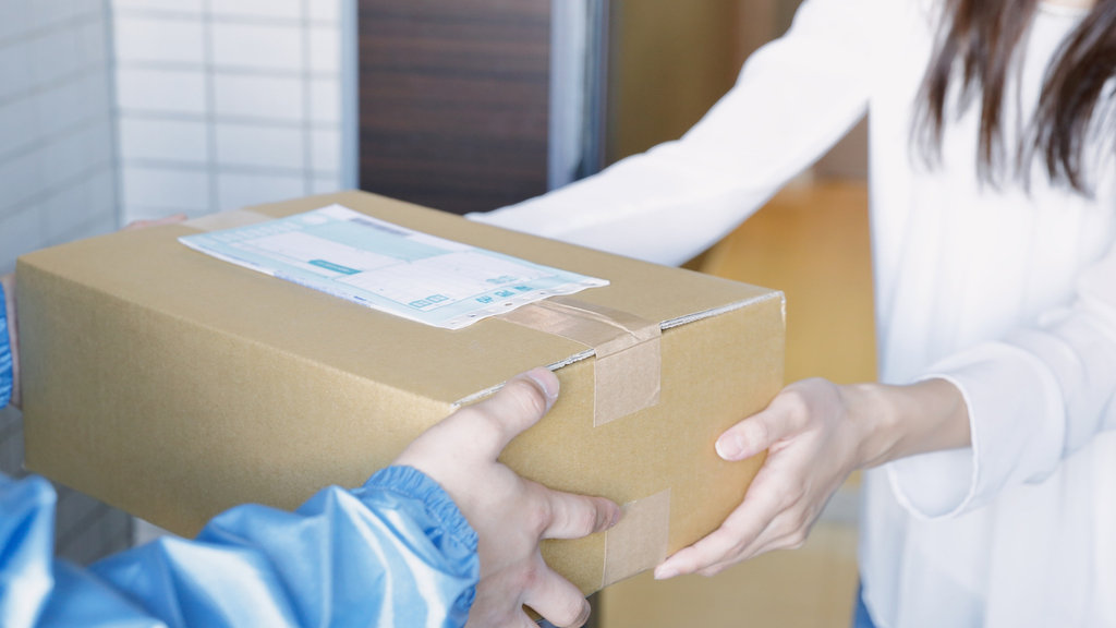 Ecommerce operations professional reviewing order and inventory data on a laptop
Worker preparing an ecommerce package for shipment and order fulfillment