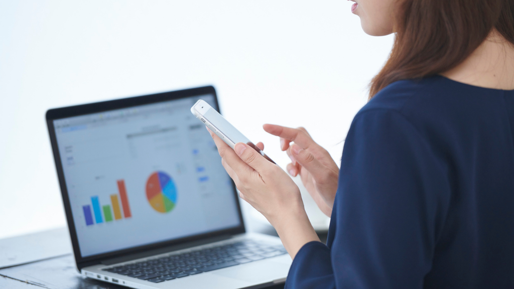 Person reviewing an ecommerce analytics dashboard on a tablet, illustrating channel-level sales and profitability reporting.