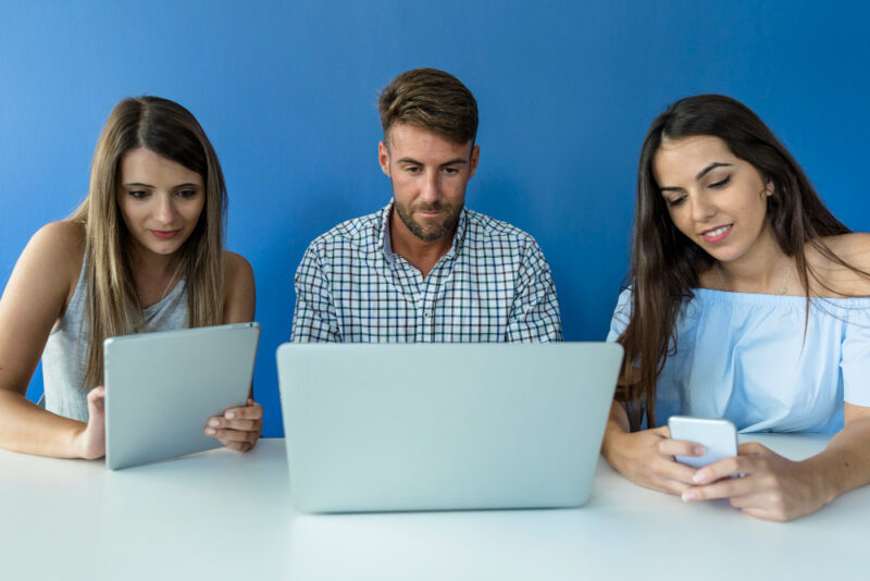 Young friends working with devices